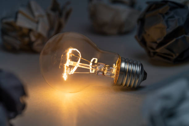 istock Idea concept with classic light bulb glowing in the dark 1470540903