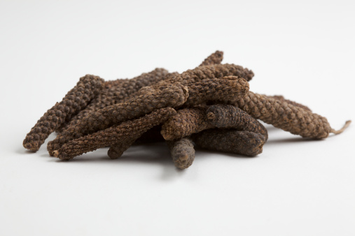 isolated long pepper corns on a white background.