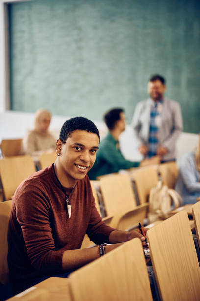 istock Happy black student attending a class at the university and looking at camera. 1470543858