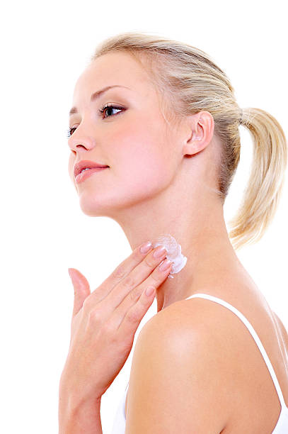 istock woman applying cream on her neck 147054572