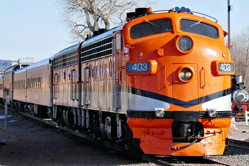 The beautiful passenger train is getting ready to depart from a train station in Colorado. At the head end of this train are two old streamlined diesel locomotives