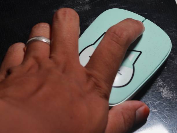 the hand that is clicking the mouse is a blue cat on a black background