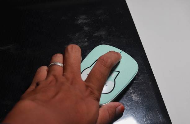 istock the hand that is clicking the mouse is a blue cat on a black background 1470548248