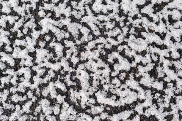 Snow texture on dark surface stock photo