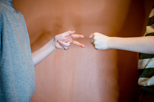 istock Rock-Paper-Scissors Showdown: rock beats scissors 1470551517
