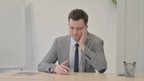 istock Tired Young Businessman with Headache at Work, Migraine 1470553382