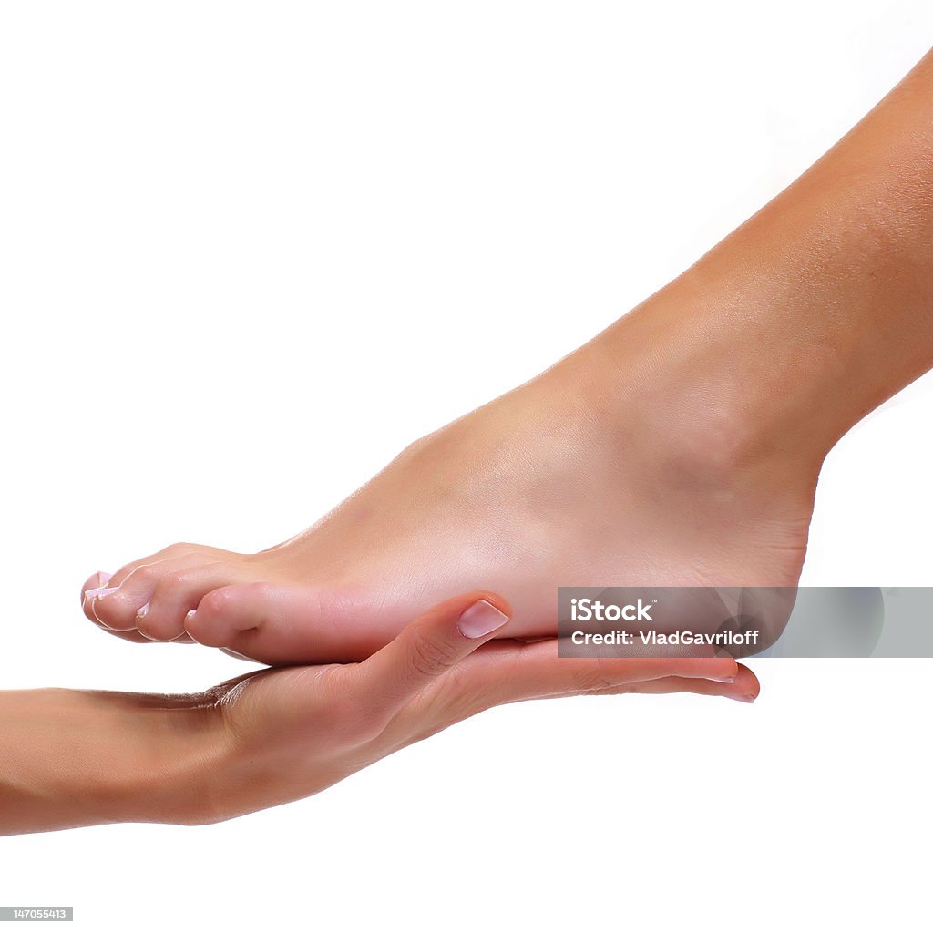 Foot being held in palm of hand isolated on white Foot of a female foot lays on a palm, isolated on a white background, please see some of my other parts of a body images: Beautiful Woman Stock Photo