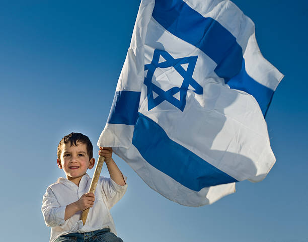istock young boy holding the Israeli flag 147055480