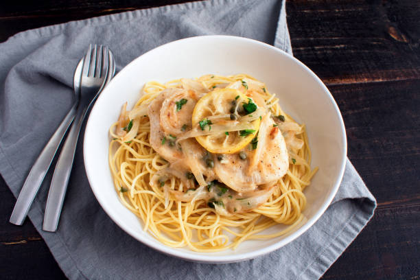 istock Chicken Piccata Served Over Spaghetti in a Pasta Bowl 1470556105