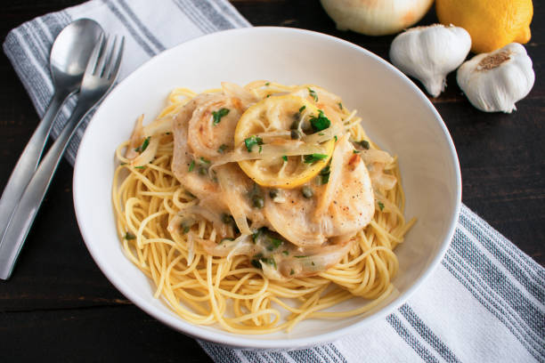 istock Chicken Piccata Served Over Spaghetti in a Pasta Bowl 1470556117