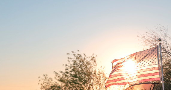 istock American flag blows at sunset 1470559477