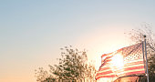 American flag blows at sunset