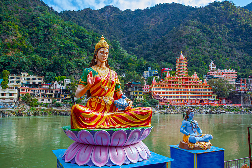 Statue of sitting goddess Parvati and Statue Shiva on the riverbank of Ganga in Rishikesh