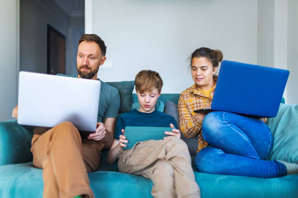 istock Father, mother and son using laptops and digital tablet 1470560133