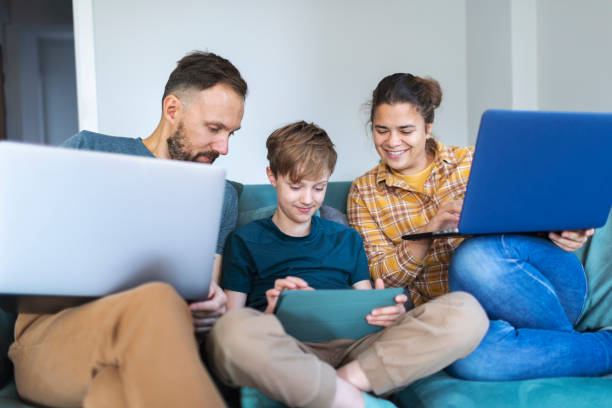 istock Father, mother and son using laptops and digital tablet 1470560711