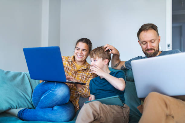istock Father, mother and son using laptops and digital tablet 1470560717