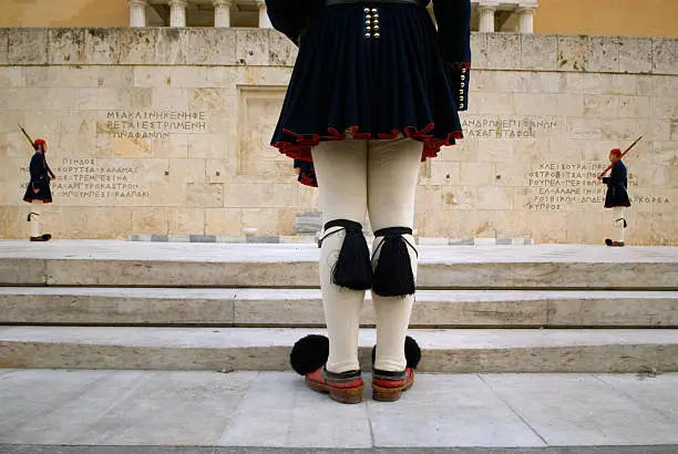 The changing of the guards ceremony takes place at the Tomb of the Unkown Soldier at the Parliament in Athens, Greece. Evzone guards, or Greek National Guards, stand in attention.