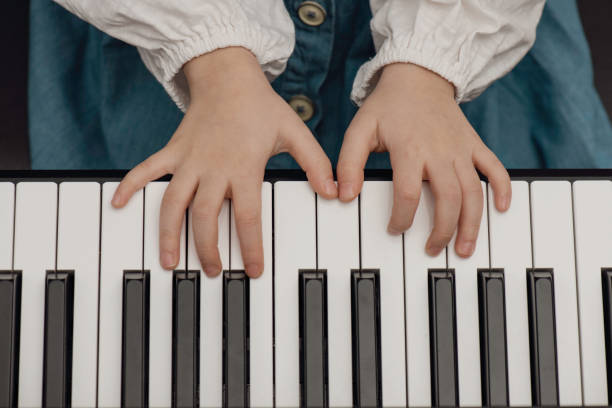 istock Little Girl Playing the Piano 1470561778