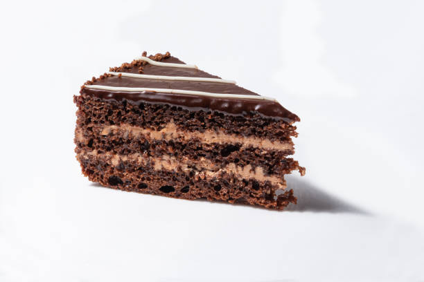 istock A piece of chocolate cake with cream on a white background. 1470562771