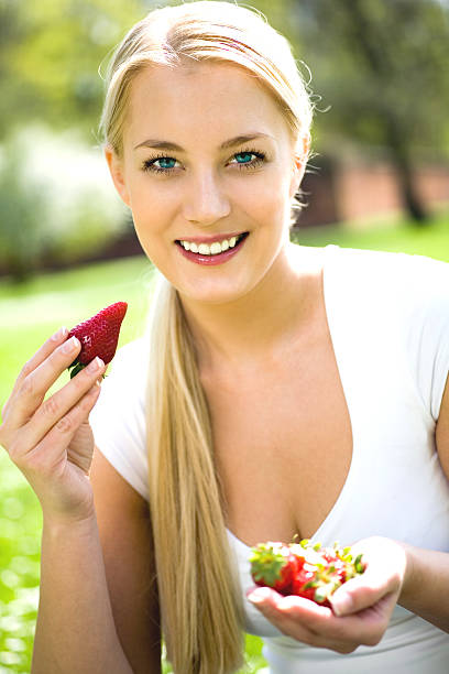 istock Woman eating strawberries 147056515