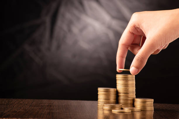 istock Saving and investing money concept, putting coin on stack 1470566058