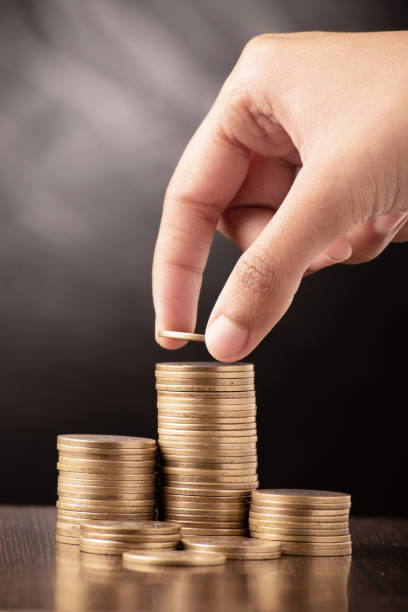 istock Hand putting coin stack investment money 1470566081