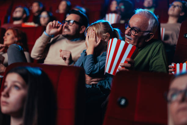 istock Scared child in movie theater. 1470566812