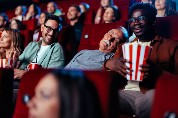 istock Senior man sleeping in cinema. 1470567392