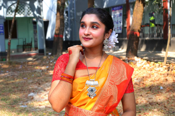 A young adult woman enjoying the celebration in traditional clothes during the spring festival. Sylhet, Bangladesh, 25 February 2023.