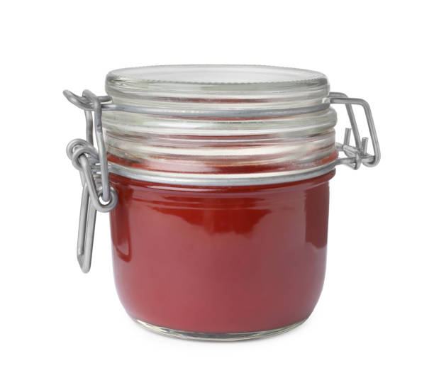 istock Tasty ketchup in glass jar isolated on white 1470569151