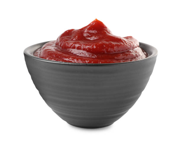 istock Tasty ketchup in bowl isolated on white 1470569258