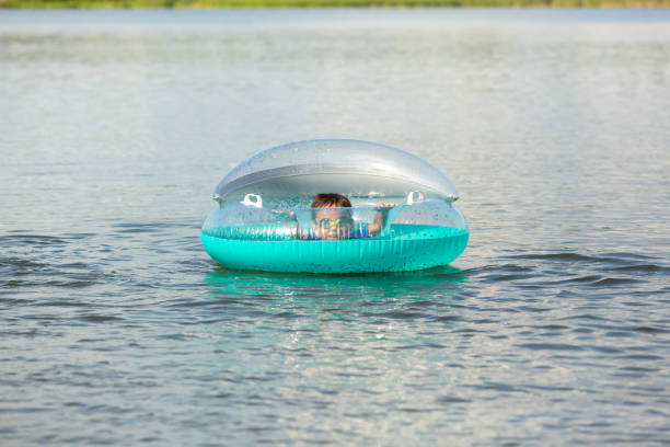 istock Boy Inside Inflatable Float at Lake on Summer Day 1470569592