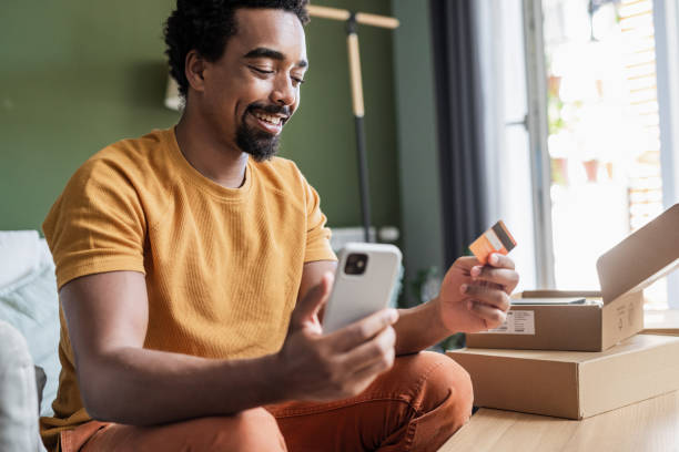 istock Young man using a smart phone to shop online 1470570685