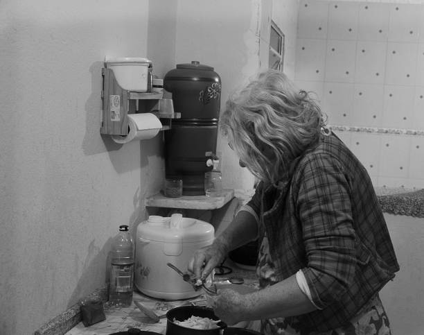Preparation of eggplant roll. The hands making eggplant roll on a white surface.