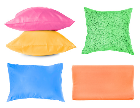 Set with different soft pillows on white background