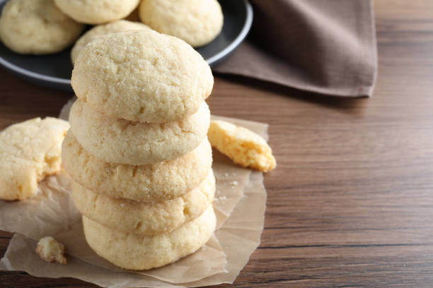 istock Stack of tasty sugar cookies on wooden table, closeup. Space for text 1470571504