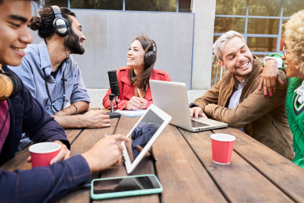 istock Woman interviewed a man for a podcast outdoors. Young people streaming with casual studio broadcasting. 1470572393