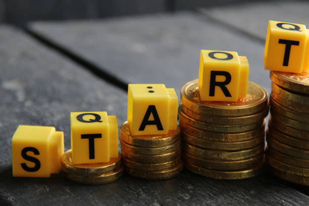 Start up concept. Golden coins on vintage background. stock photo