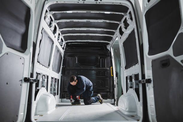 istock Converting a van into a home on wheels. Man working with a battery-powered drill inside a van. 1470572464