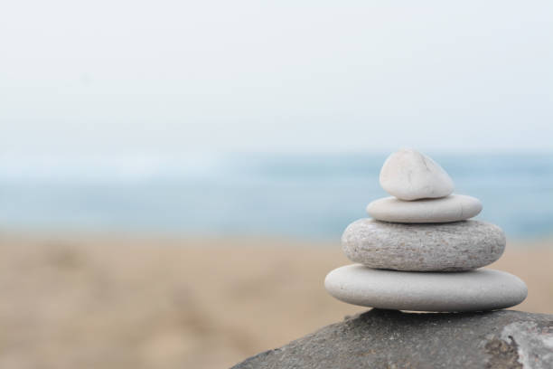 istock Stack of stones on rock near sea, space for text 1470573269