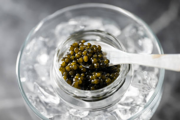 istock black caviar on ice with pearl spoon 1470573273