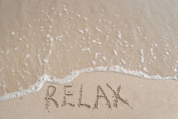 istock inscription Relax on a sand and small wave 147057395