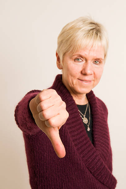 istock mature woman thumbs down 147057419
