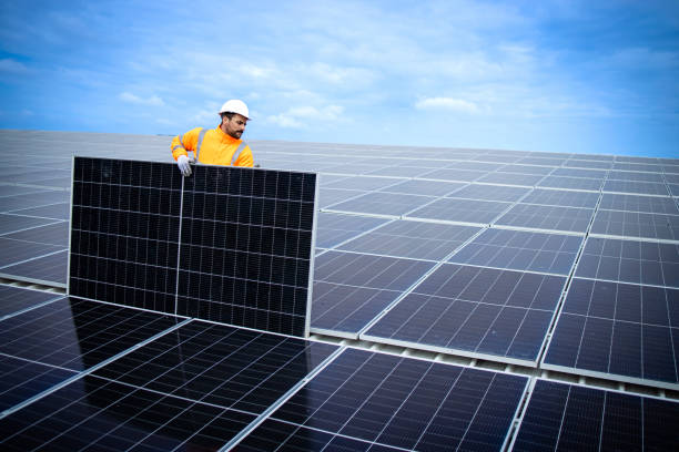 istock Professional worker installing solar panels for sustainable energy power plant. 1470574658