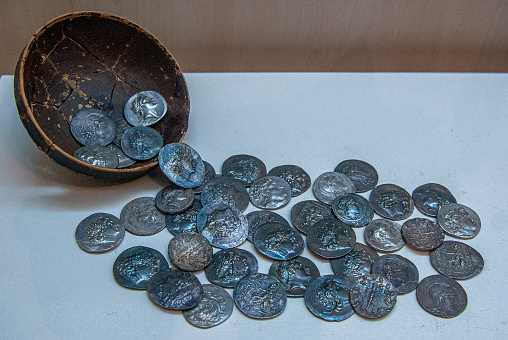 Coins in clay pot