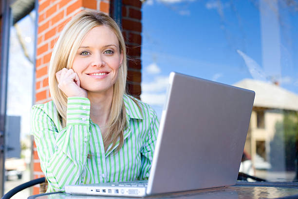 istock Business Woman sitting at a cafe working 147057619