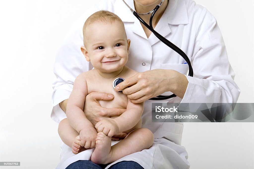 doctor examining baby young doctor with happy baby making examination Pediatrician Stock Photo