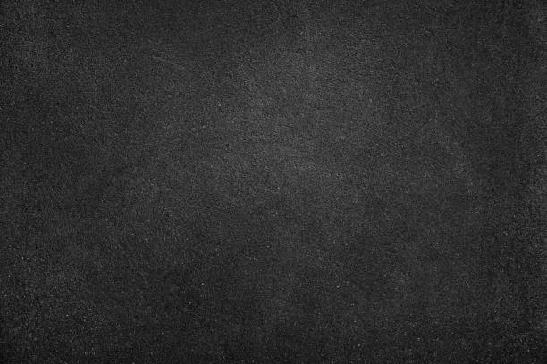 Black white texture background with space for design. Dark gray rough concrete wall surface. Close-up.