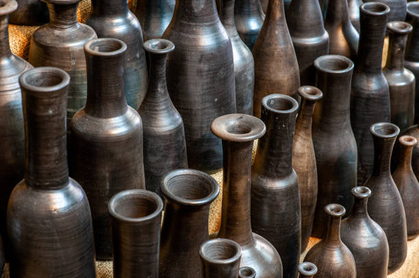 Various sizes of black painted vases - Diagonal view