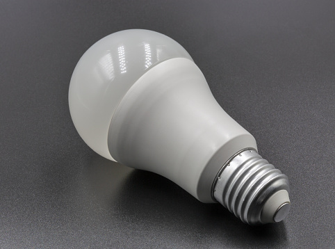 LED new technology light bulb closeup on black. Energy super saving electric lamp is good for environment.
